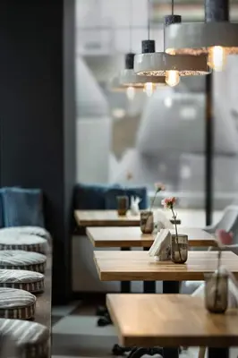 a row of tables and chairs in a restaurant at Luxury Apartments, self check in 24 h & Free Parking in Kraków