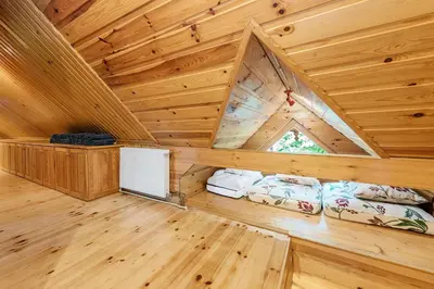 a log cabin with two beds in the attic at Chata pod 7 lipami in Jaworzna