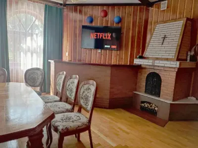 a dining room with a table and a fireplace at Willa Emil z BALIĄ ogrodową in Stróża