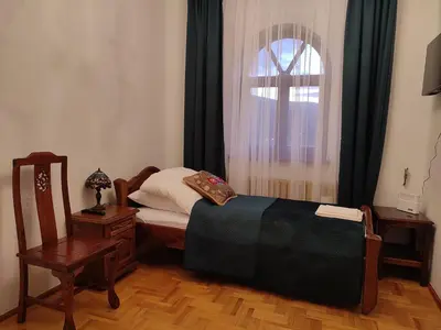 a small bedroom with a bed and a window at Willa Emil z BALIĄ ogrodową in Stróża