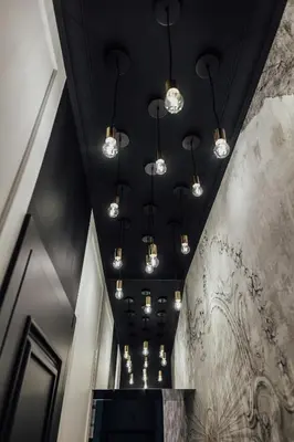 a hallway with black ceilings and lights on the ceiling at CityPlace Apartment Starowiślna 43 in Kraków