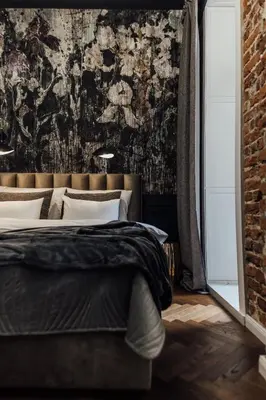 a bedroom with a large bed with a brick wall at CityPlace Apartment Starowiślna 43 in Kraków