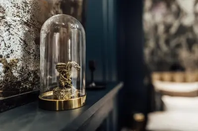 a glass cloche with a figurine of a horse on a table at CityPlace Apartment Starowiślna 43 in Kraków
