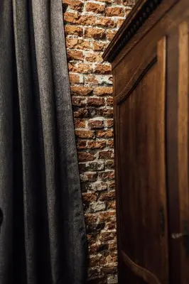 a brick wall next to a wooden door at CityPlace Apartment Starowiślna 43 in Kraków