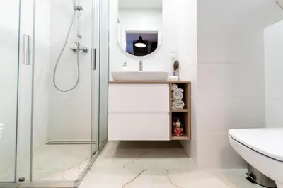a bathroom with a sink and a shower at Nowohucka Apartament in Kraków