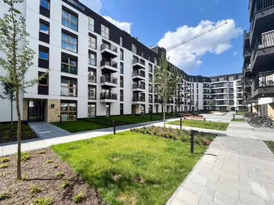 an apartment building with a lawn in front of it at Nowohucka Apartament in Kraków