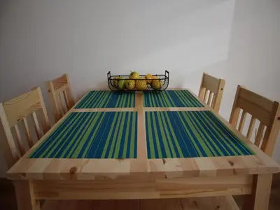 a wooden table with a basket of fruit on it at Bianca Studio in Kraków