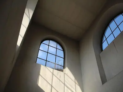 two windows in a building with sunlight streaming through them at Bianca Studio in Kraków