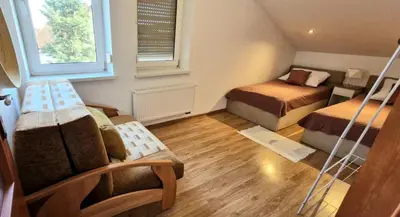 a living room with a table and chairs and a couch at Cozy Apartament Country 6persons close to airport in Kraków