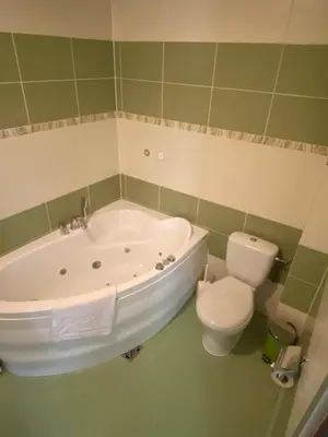 a bathroom with a tub and a toilet at Zajazd Miechus in Miechów
