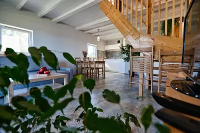 a living room with a blue couch and a table at 3 Stodoły-domek 1 in Zator