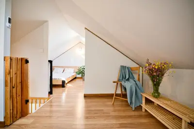a living room with a staircase and a couch at 3 Stodoły-domek 1 in Zator