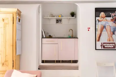 a kitchen with white cabinets and a sink at Tomte - scandinavian apartment in Kraków