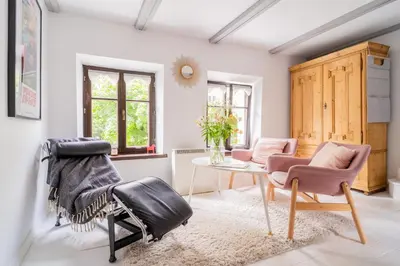 a living room with two chairs and a table at Tomte - scandinavian apartment in Kraków