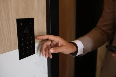 a man in a suit is unlocking a door at Resto Inn - Smart apartamenty blisko Energylandii in Po”łwieś