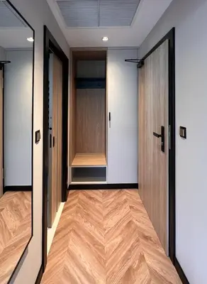 a hallway with two doors and a wooden floor at Resto Inn - Smart apartamenty blisko Energylandii in Po”łwieś