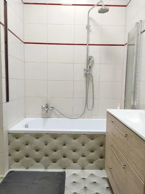a kitchen with a sink and a clock on the wall at Nice Place in Kraków
