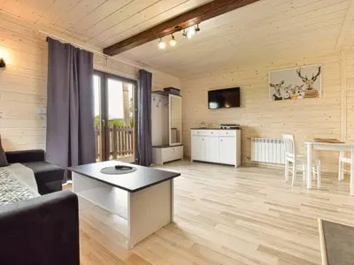 a living room with a couch and a table at Domek Leniuchowo in Rabka