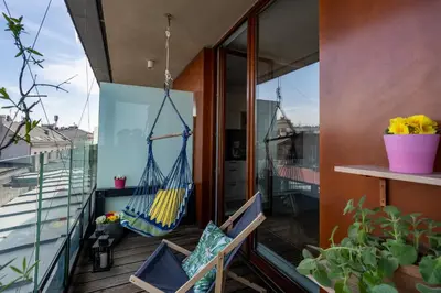 a room with a balcony with a hammock at Tukan Old Town in Kraków