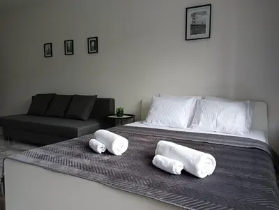a bed with three rolled towels on top of it at Apartamenty Oświęcim klimatyzacja air-conditioned in Oświęcim