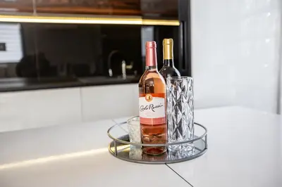two bottles of wine sitting on top of a counter at Wlodarska 4a Apartament Premium in Kraków