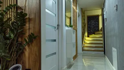a hallway with a door and stairs in a house at Wlodarska 4a Apartament Premium in Kraków