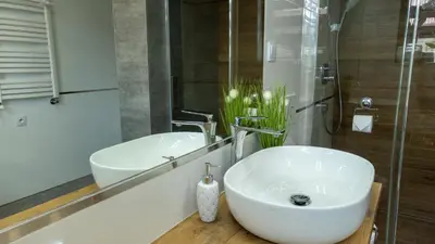 a bathroom with a white sink and a mirror at Wlodarska 4a Apartament Premium in Kraków