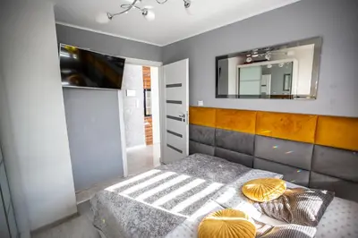 a bedroom with a bed and a mirror at Wlodarska 4a Apartament Premium in Kraków