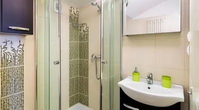 a bathroom with a shower and a sink at Apartments Legendary Kraków in Kraków