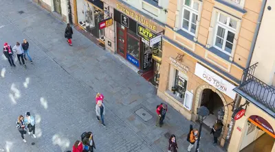 a group of people walking on a street in a city at Apartments Legendary Kraków in Kraków