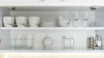 a shelf filled with glasses and wine glasses at Apartments Legendary Kraków in Kraków