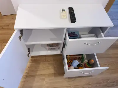 a white desk with a drawer and a remote control at Apartments Legendary Kraków in Kraków