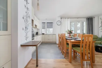 a kitchen and dining room with a table and chairs at Ruczaj Apartment Cracow Dębniki by Noclegi Renters in Kraków