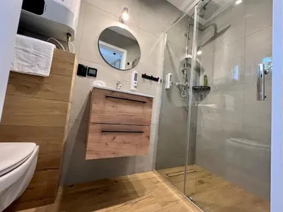 a bathroom with a shower and a sink and a toilet at Jaśminowa Park in Zator