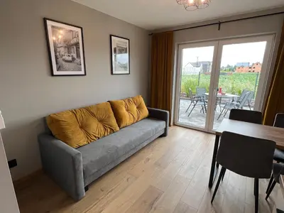 a living room with a couch and a table at Jaśminowa Park in Zator