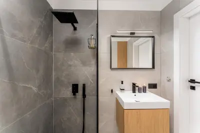 a bathroom with a sink and a shower at Verona House - Premium Apartment in Kraków