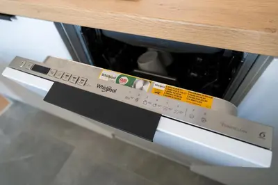 a microwave oven sitting under a wooden table at Verona House - Premium Apartment in Kraków