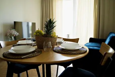 a wooden table with a bowl of fruit on it at Apartament Thaddeus 48 z tarasem in Zator