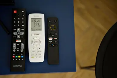 a group of remote controls sitting on a blue table at Apartament Thaddeus 48 z tarasem in Zator