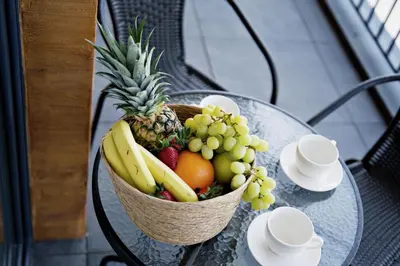 a basket of fruit on a glass table at Apartament Thaddeus 48 z tarasem in Zator