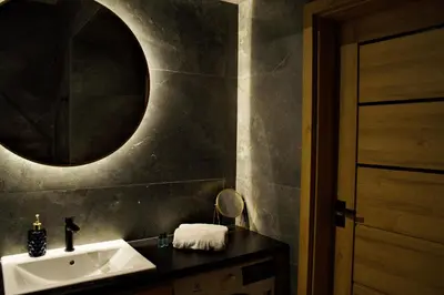 a bathroom with a sink and a mirror at Apartament Thaddeus 48 z tarasem in Zator