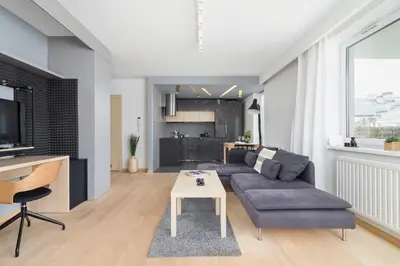 a living room with a couch and a table at Stawowa Apartment with Balcony & Parking Cracow by Noclegi Renters in Kraków
