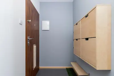 a room with a wooden cabinet and a door at Stawowa Apartment with Balcony & Parking Cracow by Noclegi Renters in Kraków