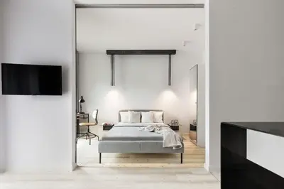 a bedroom with a bed and a flat screen tv at Deluxe apartment in City Center, Steam Park in Kraków