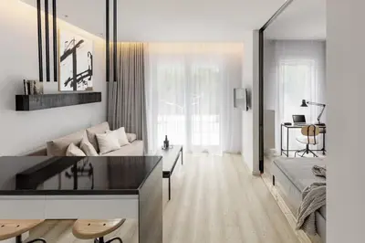 a white living room with a couch and a table at Deluxe apartment in City Center, Steam Park in Kraków
