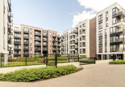 a row of apartment buildings with a fence at Deluxe apartment in City Center, Steam Park in Kraków