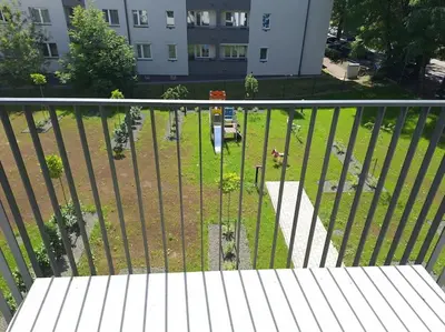 a view of a park through a fence at New Funcional Easy Stay High Standard Kraków apartment free garage parking in Kraków