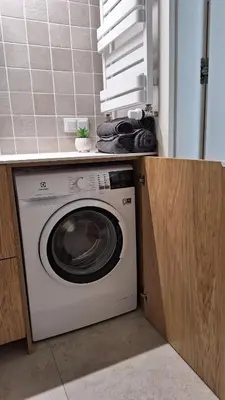 a washing machine under a counter in a kitchen at New Funcional Easy Stay High Standard Kraków apartment free garage parking in Kraków
