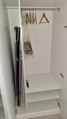 a white closet with stairs and purses at New Funcional Easy Stay High Standard Kraków apartment free garage parking in Kraków