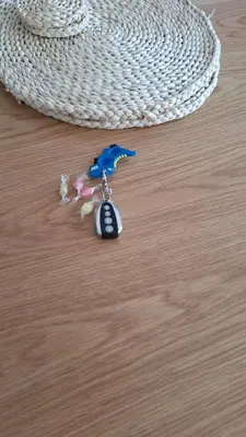 a toy key chain with a toy gun on a table at New Funcional Easy Stay High Standard Kraków apartment free garage parking in Kraków
